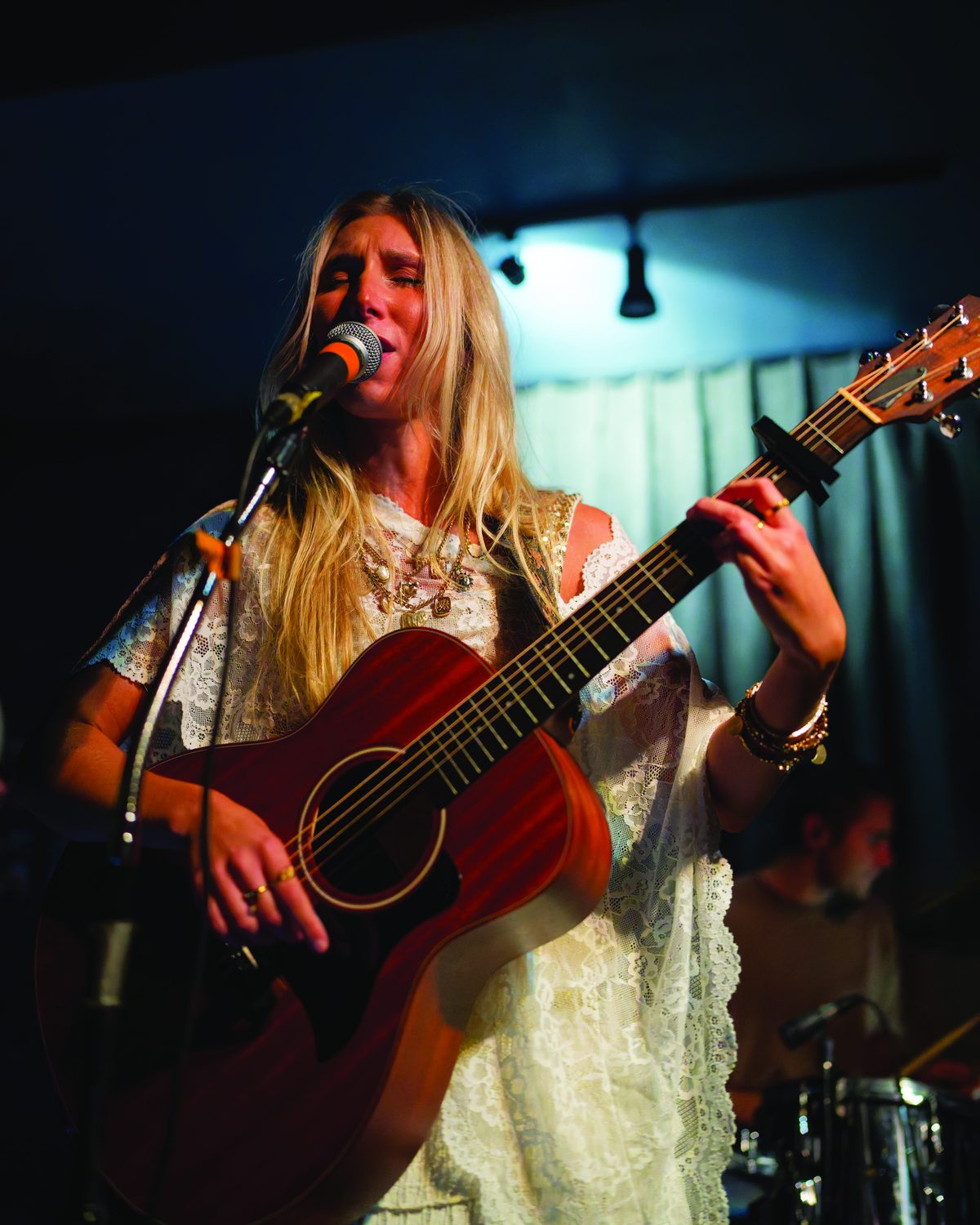 Sylvie singing and playing acoustic guitar