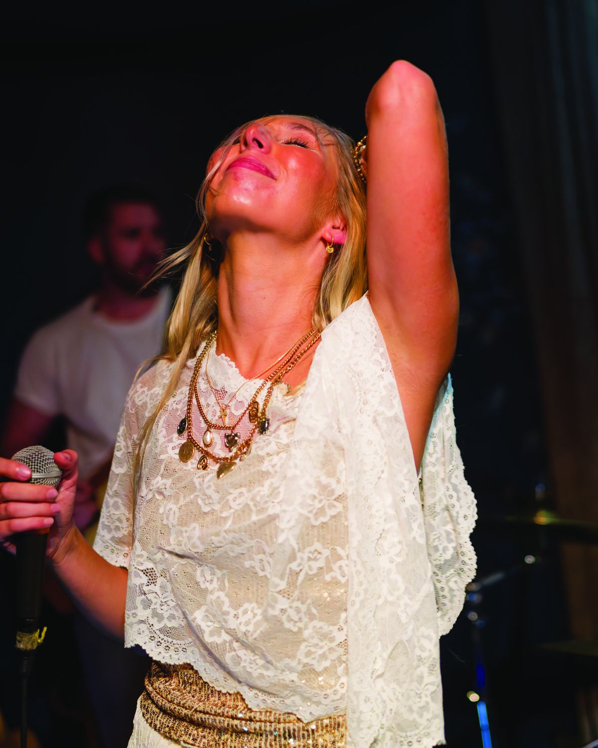 Sylvie looking up, arm raised